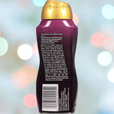 A purple bottle with a gold cap is displayed against a blurred background of multicolored lights. The label identifies it as Trojan H2O Closer, a water-based lubricant by Trojan, offering advanced personal comfort with detailed text and a barcode to complete its presentation.